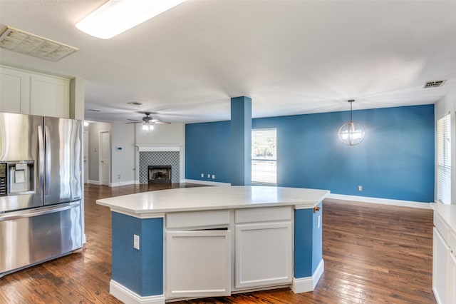 kitchen with a kitchen island, white cabinets, dark hardwood / wood-style flooring, hanging light fixtures, and stainless steel refrigerator with ice dispenser