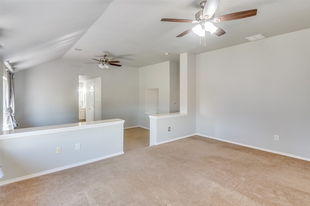 unfurnished room featuring light carpet, lofted ceiling, and ceiling fan