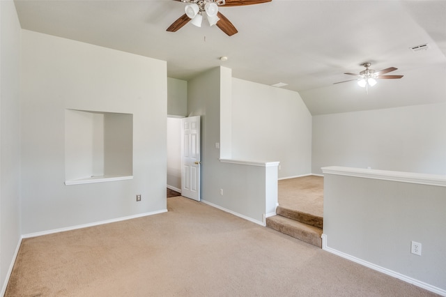 carpeted empty room featuring lofted ceiling and ceiling fan