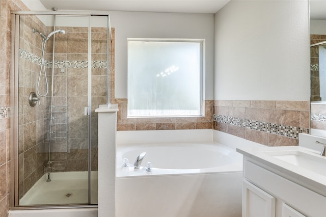 bathroom featuring vanity and plus walk in shower