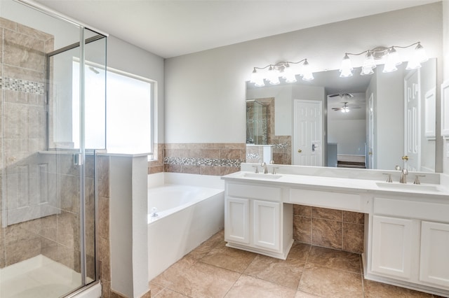 bathroom featuring ceiling fan, vanity, plus walk in shower, and tile patterned flooring