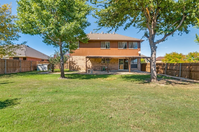 back of property featuring a lawn and a patio area