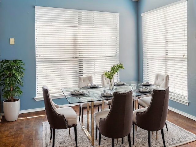 dining space with dark hardwood / wood-style flooring and a wealth of natural light