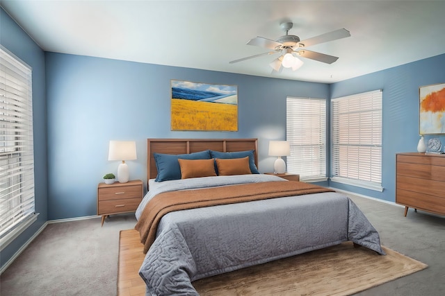 bedroom with ceiling fan and light carpet