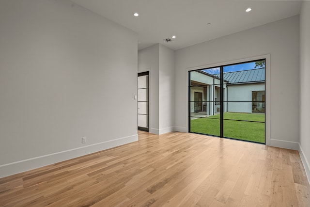 spare room with light hardwood / wood-style floors