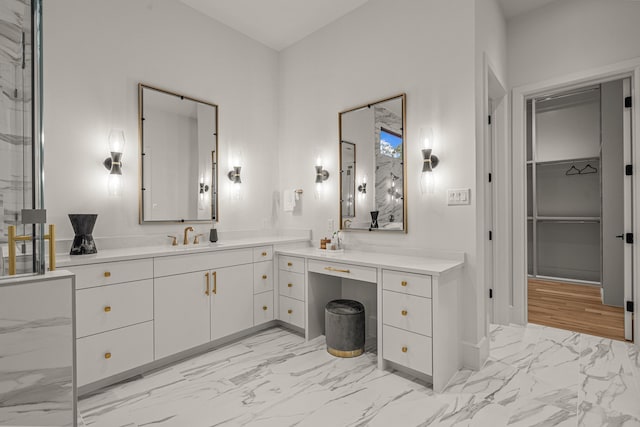 full bathroom featuring baseboards, marble finish floor, and vanity