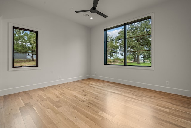 spare room with ceiling fan, a wealth of natural light, and baseboards