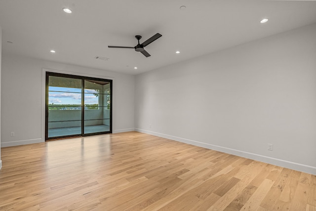 empty room with baseboards, light wood-style floors, and recessed lighting