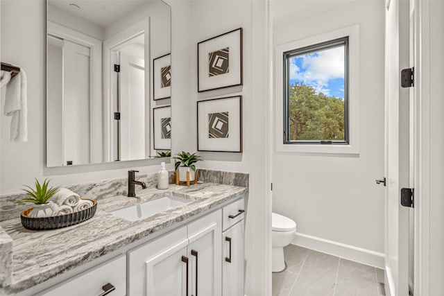 bathroom featuring vanity and toilet