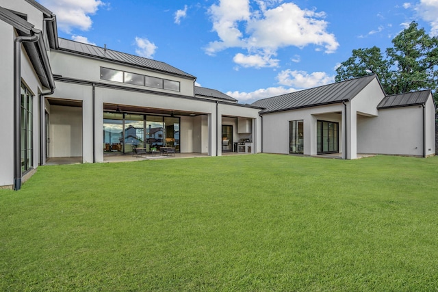 rear view of property with a lawn