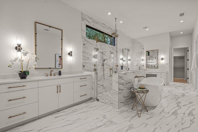 full bath with a freestanding tub, a marble finish shower, recessed lighting, and marble finish floor