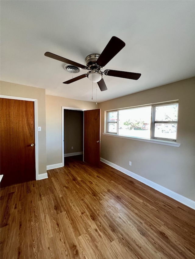 unfurnished bedroom featuring hardwood / wood-style floors and ceiling fan