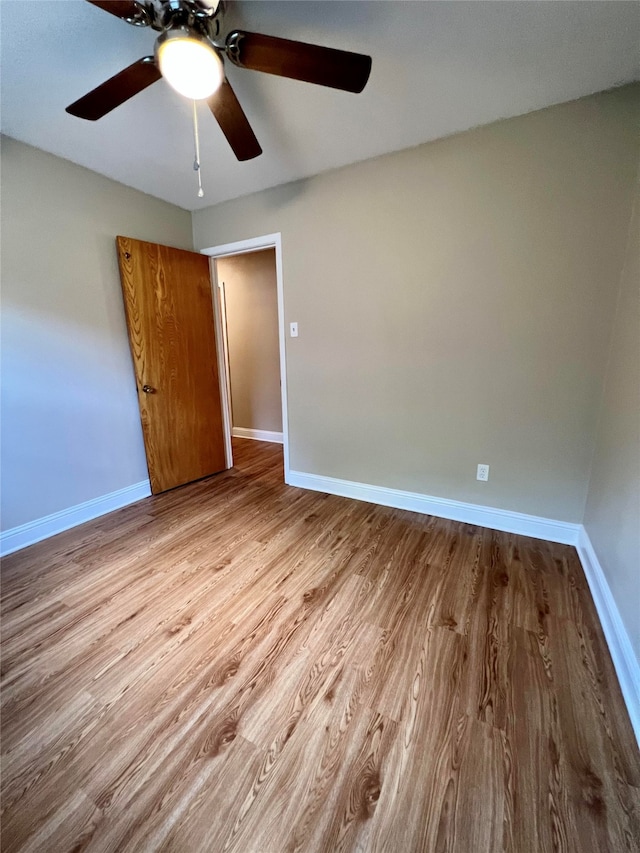 unfurnished bedroom with ceiling fan and light hardwood / wood-style flooring