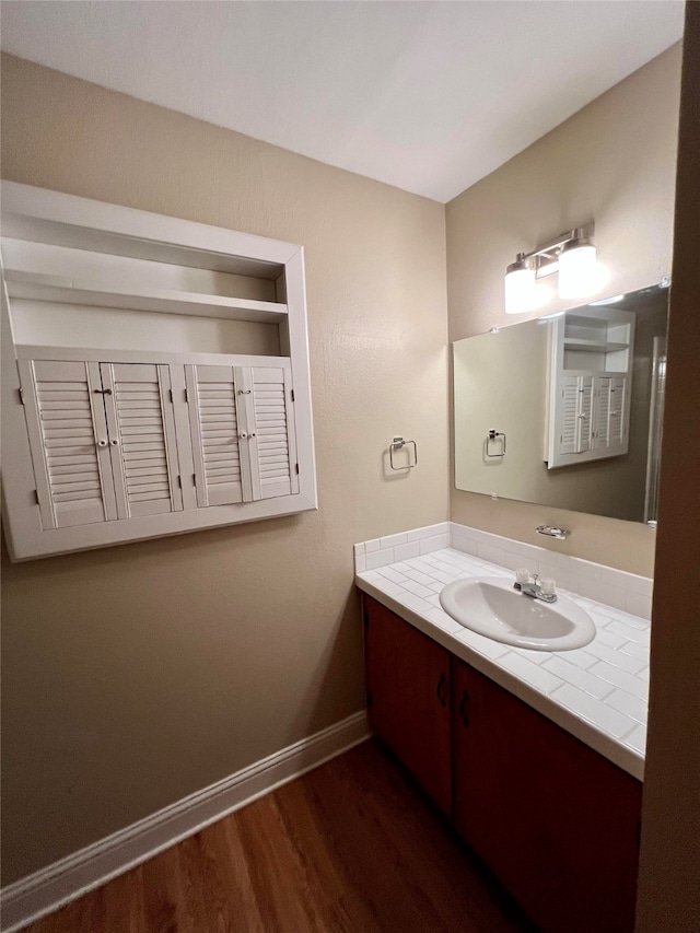 bathroom with vanity and hardwood / wood-style floors