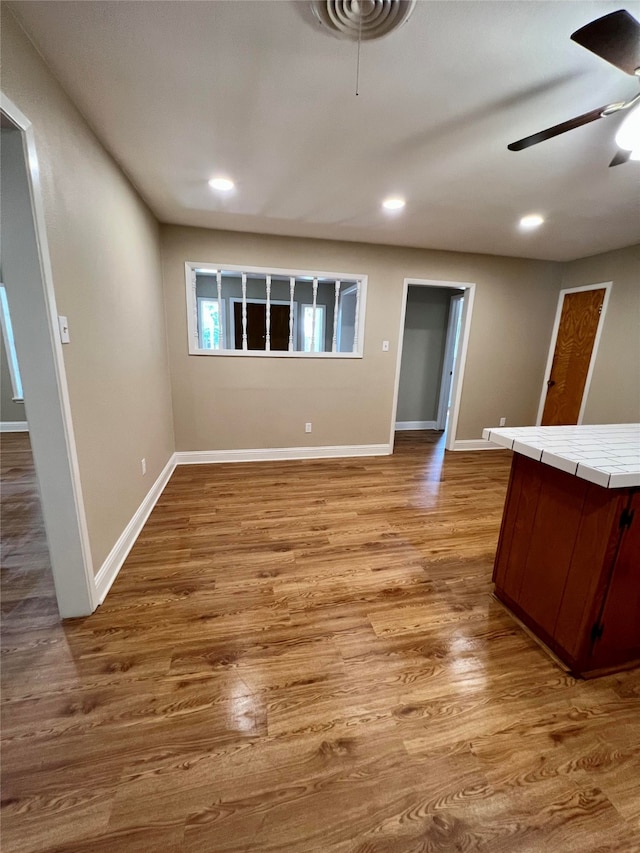 interior space featuring light hardwood / wood-style floors and ceiling fan