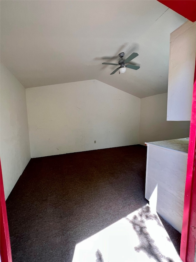 bonus room featuring lofted ceiling, carpet flooring, and ceiling fan