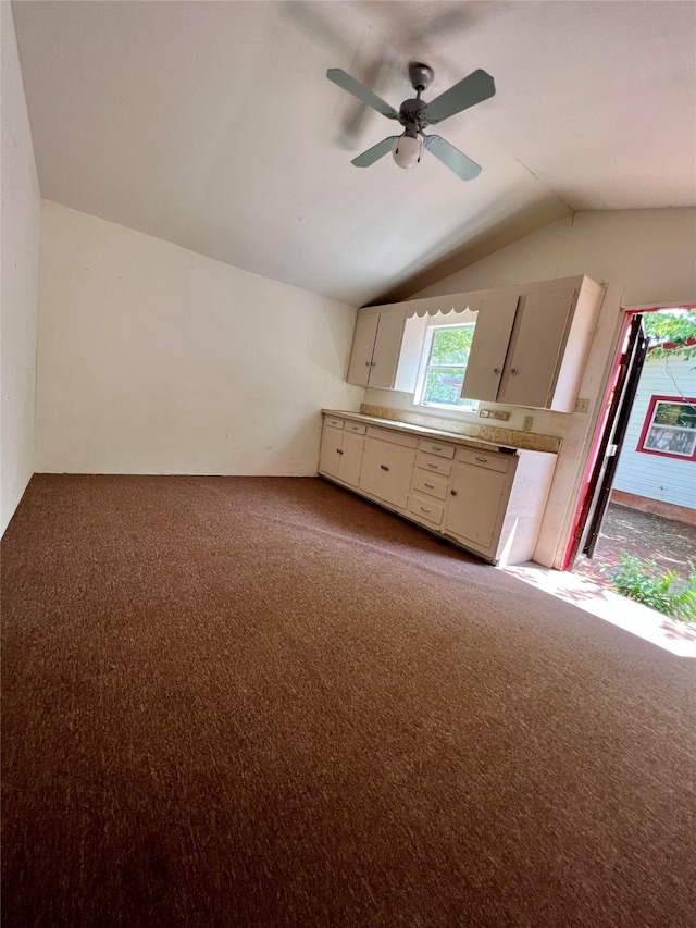 interior space with light carpet, vaulted ceiling, and ceiling fan