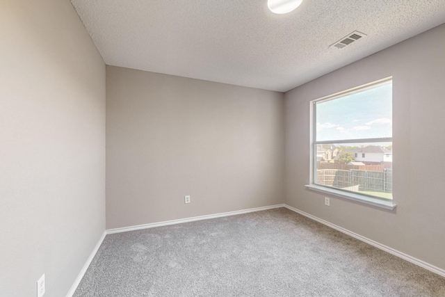 unfurnished room featuring carpet flooring and a textured ceiling