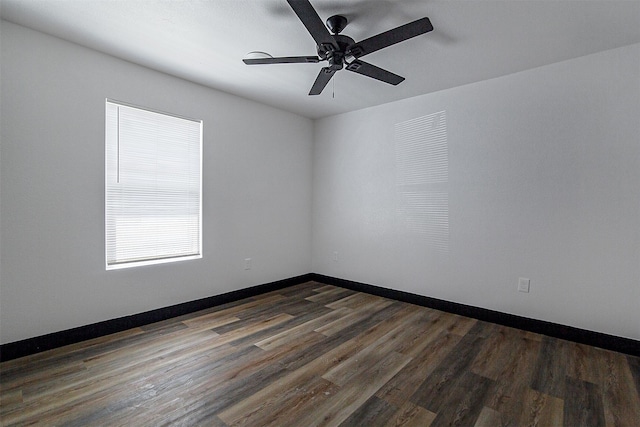 empty room featuring ceiling fan and dark hardwood / wood-style floors