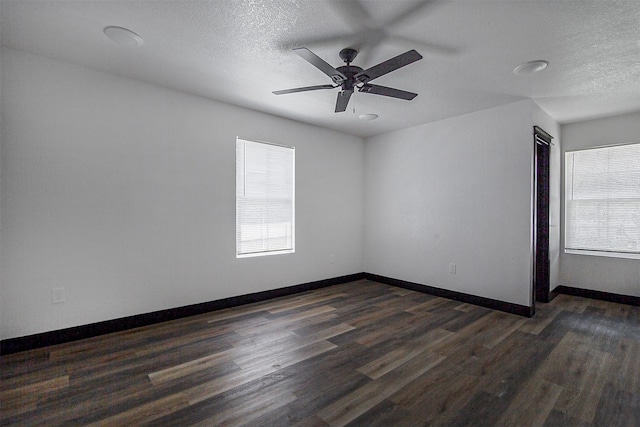 spare room featuring ceiling fan, a textured ceiling, and dark wood-type flooring