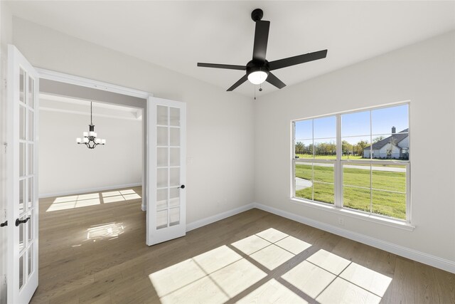 170 Waterview Dr, Gunter, TX 75058 - unfurnished room with ceiling fan with notable chandelier, wood finished floors, french doors, and baseboards