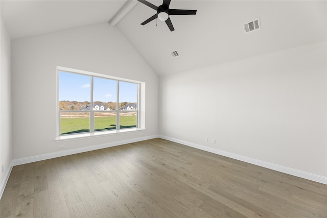 empty room featuring a ceiling fan, visible vents, beamed ceiling, and wood finished floors