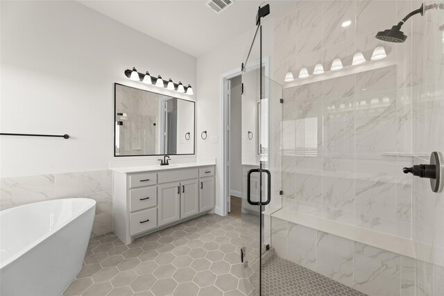 170 Waterview Dr, Gunter, TX 75058 - bathroom with visible vents, a stall shower, a freestanding bath, and tile walls