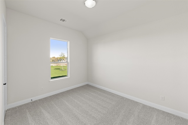 spare room featuring baseboards, visible vents, and carpet flooring