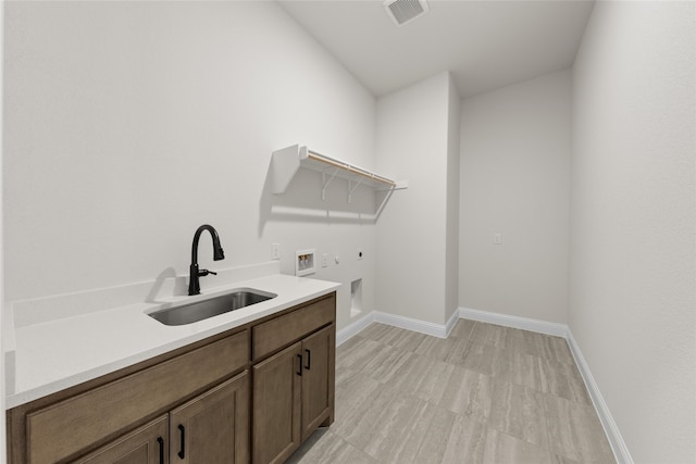 170 Waterview Dr, Gunter, TX 75058 - laundry room featuring visible vents, hookup for a washing machine, cabinet space, hookup for an electric dryer, and a sink