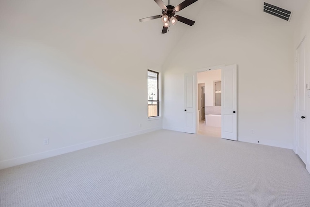 unfurnished room featuring light carpet, high vaulted ceiling, and ceiling fan