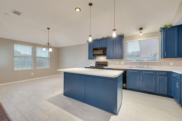 kitchen featuring lofted ceiling, a center island, stainless steel appliances, sink, and blue cabinets