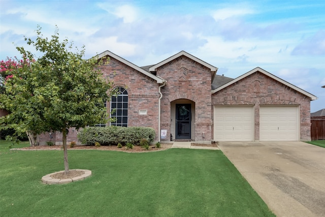 view of front of property featuring a front yard and a garage