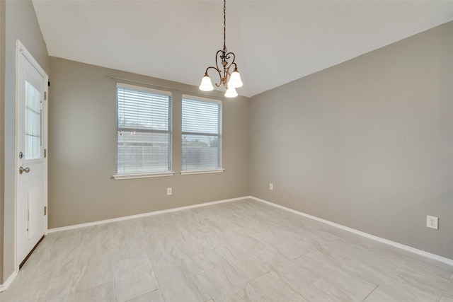 spare room with an inviting chandelier