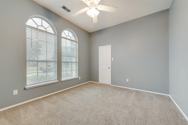 spare room featuring ceiling fan and carpet flooring