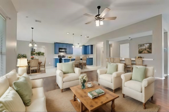 living room with wood-type flooring and ceiling fan with notable chandelier