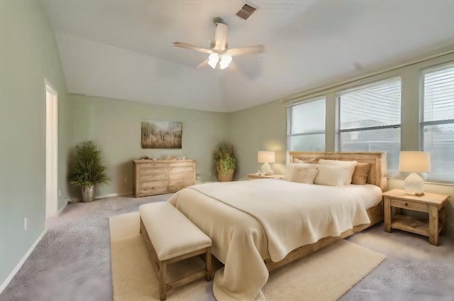 carpeted bedroom with ceiling fan and vaulted ceiling