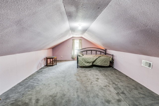 unfurnished bedroom featuring carpet floors, a textured ceiling, and vaulted ceiling