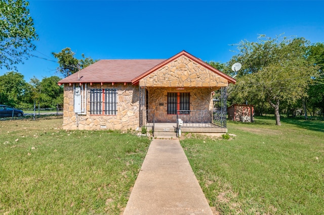 view of front of house with a shed and a front lawn