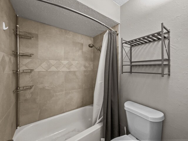 bathroom with vanity, toilet, a textured ceiling, and curtained shower