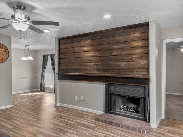 foyer entrance with light hardwood / wood-style flooring and a textured ceiling