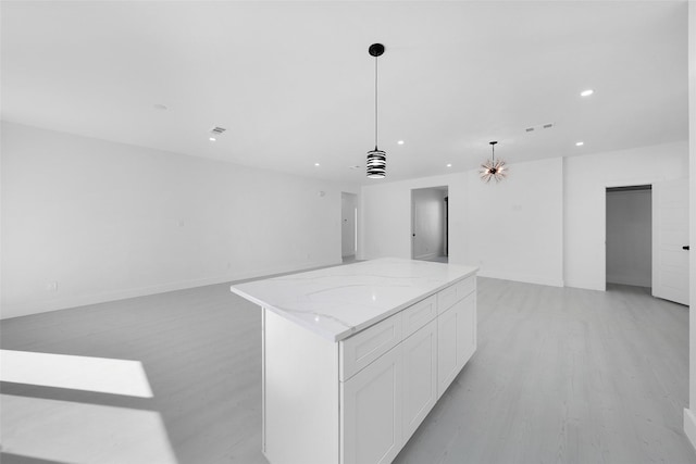309 W Beckham St W, Sulphur Springs, TX 75482 - kitchen with open floor plan, recessed lighting, white cabinetry, a kitchen island, and light wood-type flooring