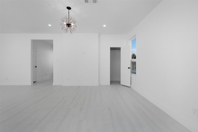 309 W Beckham St W, Sulphur Springs, TX 75482 - empty room with light wood-style floors, a chandelier, recessed lighting, and baseboards