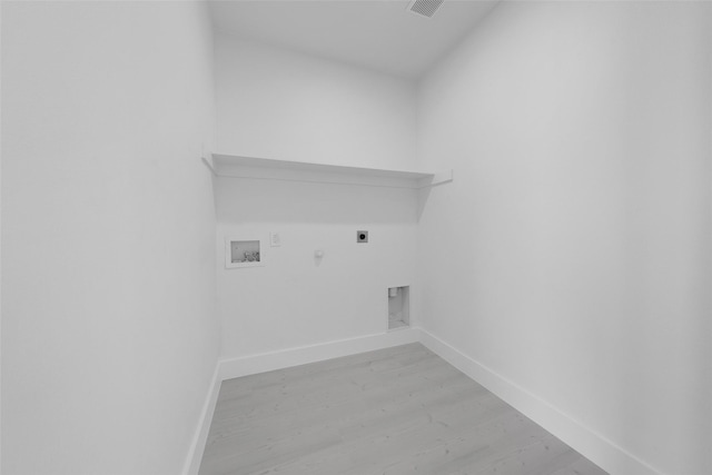 309 W Beckham St W, Sulphur Springs, TX 75482 - laundry room featuring hookup for an electric dryer, hookup for a gas dryer, light wood-style flooring, hookup for a washing machine, and baseboards