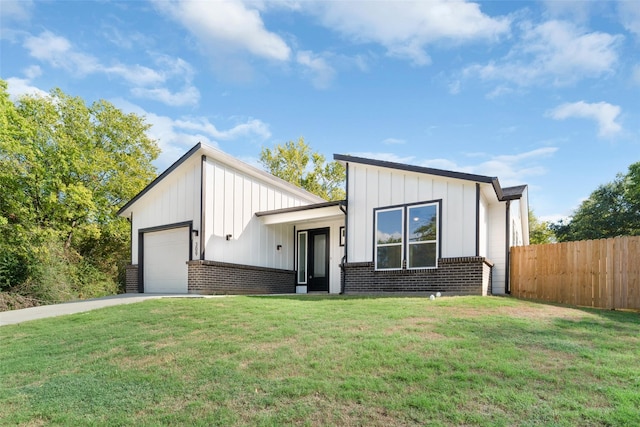 309 W Beckham St W, Sulphur Springs, TX 75482 - view of front facade with a garage, board and batten siding, brick siding, and concrete driveway