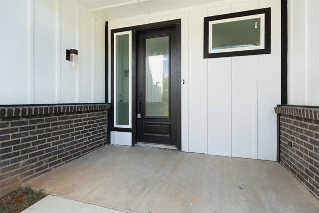 309 W Beckham St W, Sulphur Springs, TX 75482 - view of exterior entry with board and batten siding