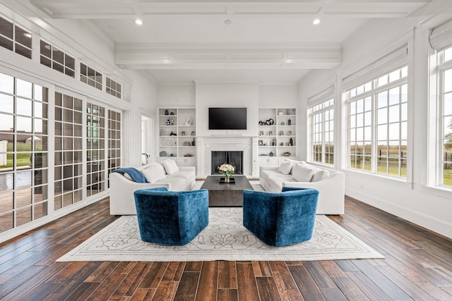 living room with beamed ceiling, dark hardwood / wood-style flooring, and built in shelves