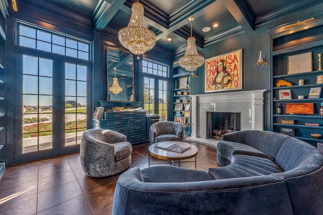 living room with a high end fireplace, crown molding, french doors, built in shelves, and a notable chandelier