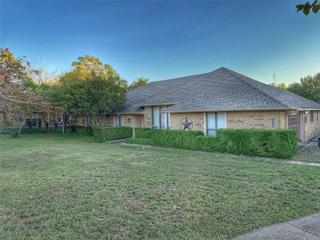 ranch-style house with a front lawn