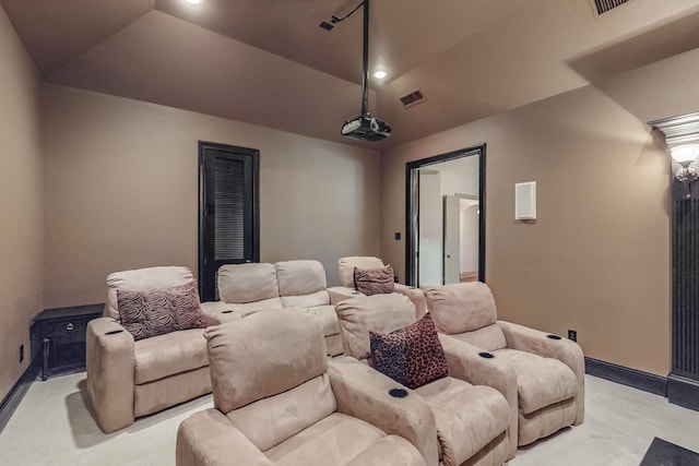 carpeted cinema with lofted ceiling