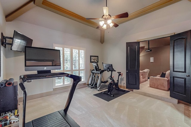 exercise room with ceiling fan and light colored carpet